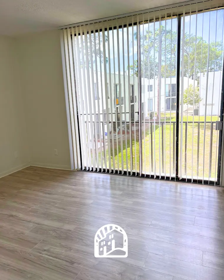 Living room with patio access in a two-bedroom townhome